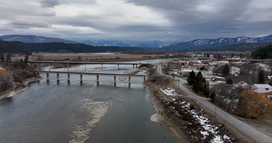 Bonners Ferry Idaho USA Aerial Drone Overview Establishing Shot Kootenay River Bridges Mountain Background