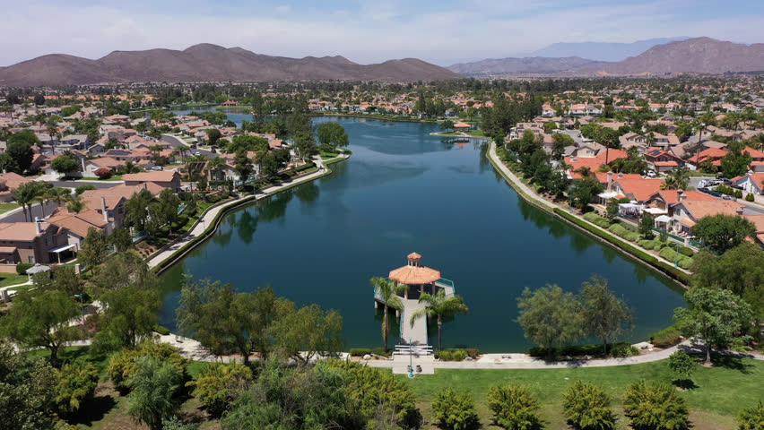 Aerial view of sprawling single family home neighborhood and lake of Menifee, California, USA.