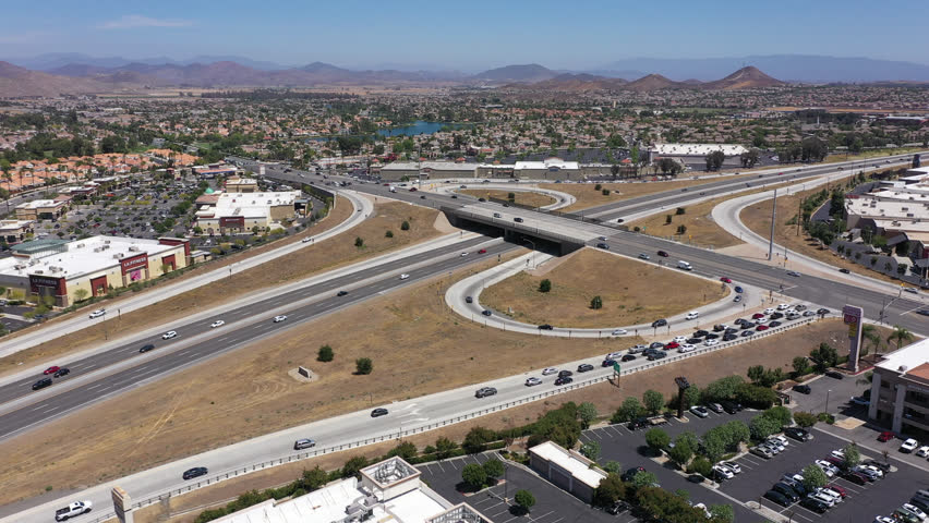 Menifee, California, USA - June 6, 2022: Afternoon light shines on the 215 freeway and downtown urban core of Menifee.