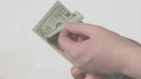 Animation of data processing american dollar banknotes over hands counting american dollar banknotes. Global currency, business, finances and digital interface concept digitally generated video.