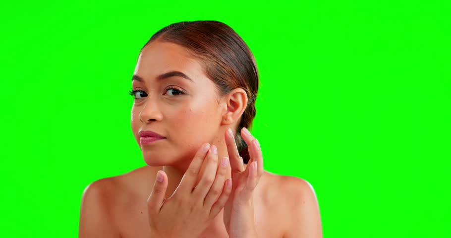 Face, skincare and woman squeeze pimple, dermatology and cosmetics on a studio background. Portrait, female and lady with breakout, blackhead or grooming for acne treatment, green screen or soft skin Royalty-Free Stock Footage #1101349783