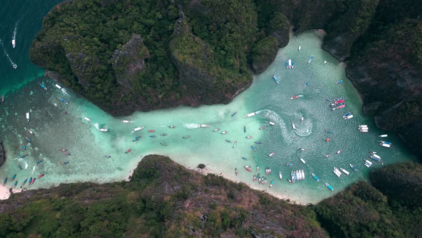 Aerial top view over tropical sea, beautiful lagoon with turquoise sea water, limestone cliffs with green vegetation. Long-tailed boats and many tourists. Pileh lagoon, Krabi, Thailand | Shutterstock HD Video #1101351645