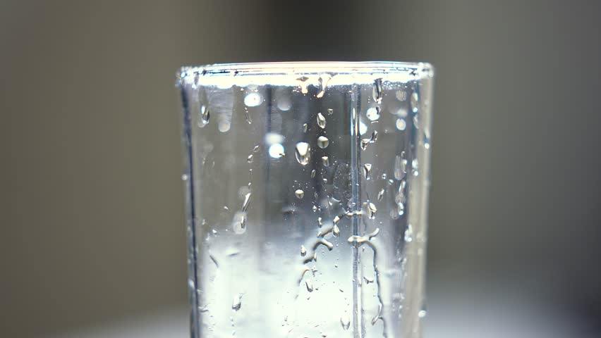 Clean drinking water from the tap. Slow motion. A glass of water, a beautiful frame. Concept: thirst, saving resources, water use, utility prices, flushing money down the drain. | Shutterstock HD Video #1101354195