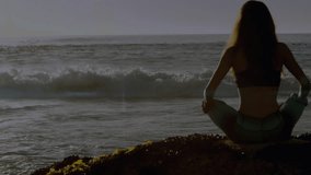 Animation of light spots over caucasian woman practicing yoga and meditating at beach. Global sport and digital interface concept digitally generated video. - Powered by Shutterstock - Get 15% off with code: PIKWIZARD15