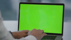 Man hands writing on green screen laptop sitting office close up. Unknown businessman typing document searching information surfing internet using mockup computer. Manager working on chroma key pc. - Powered by Shutterstock - Get 15% off with code: PIKWIZARD15