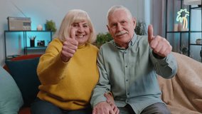 Like. Happy senior family grandparents man woman showing thumbs up, like sign positive something good, positive feedback at home. Elderly grandmother, grandfather couple sitting on sofa in living room - Powered by Shutterstock - Get 15% off with code: PIKWIZARD15