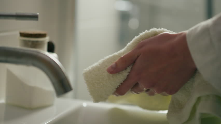 The girl wipes her feminine hands with a towel while standing in the bathroom, A young woman washed her hands with soap making sure that her hands are clean wipes with a towel is in a public toilet
 | Shutterstock HD Video #1101361195