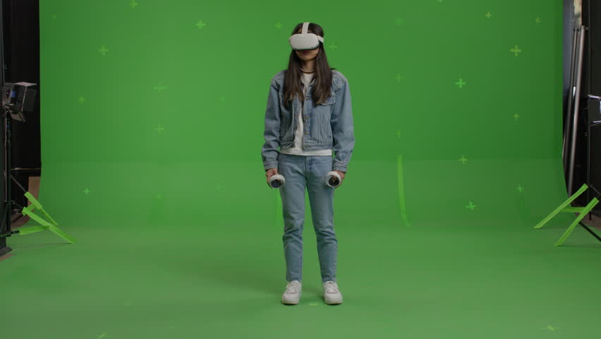 GREEN SCREEN CHROMA KEY Full portrait of Asian female using VR headset - Powered by Shutterstock - Get 15% off with code: PIKWIZARD15