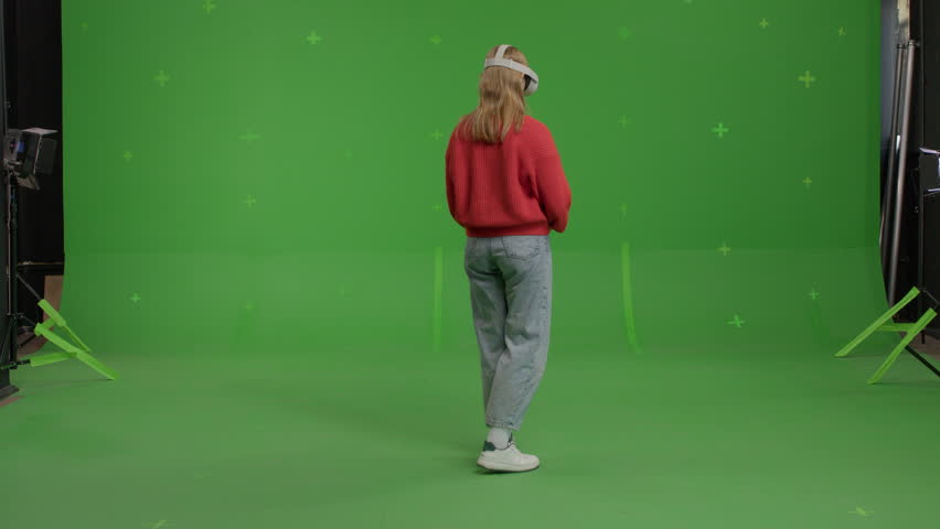 GREEN SCREEN CHROMA KEY Full portrait of 20s Caucasian female using VR headset - Powered by Shutterstock - Get 15% off with code: PIKWIZARD15