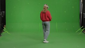 GREEN SCREEN CHROMA KEY Full portrait of 20s Caucasian female using VR headset - Powered by Shutterstock - Get 15% off with code: PIKWIZARD15