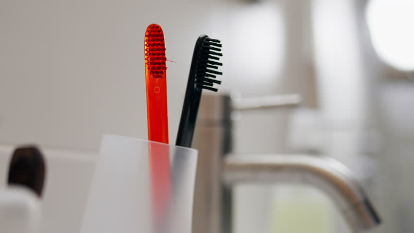 Using biodegradable toothbrushes made from cornstarch instead of plastic, Person's efforts to reduce plastic waste, Choosing eco-friendly dental care products, Mindful decision to protect environment
 | Shutterstock HD Video #1101362223