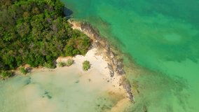 Experience the mesmerizing beauty of a green island with sandy beaches and rocks surrounded by turquoise waters with a drone. Discover a paradise on earth. Thailand. nature and travel concept. 4K UHD
