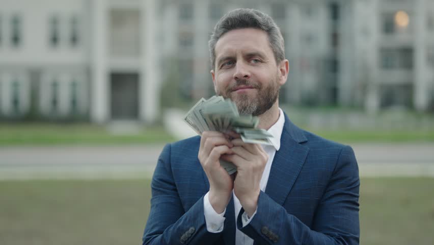 Love money. Slow motion of man counting money outdoor. Man with money cash outdoor. Dollar banknotes. Portrait of man holding bunch of money banknotes. Dollar bills, credit, online banking. Royalty-Free Stock Footage #1101364565