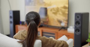 Woman play video game on television at home 