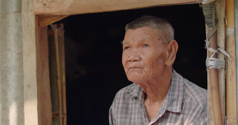 The Asian male farmer who is a poor elderly native looks up at the sky as though something had happened. Used in humanity, documentary, lonely person, environment, concepts, or movies.  Royalty-Free Stock Footage #1101366083