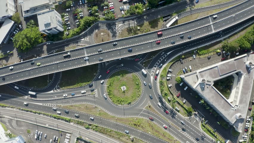 Descending aerial top down shot of traffic on highway and roundabout during sunny day - Vacoas Phoenix, Mauritius Royalty-Free Stock Footage #1101370149