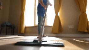 Little girl helper cleans room. Child is doing cleaning in house. Girl wipes dust from floor with damp mop. Wet floor cleaning. Child helps around house, taking care of cleanliness. little helper - Powered by Shutterstock - Get 15% off with code: PIKWIZARD15
