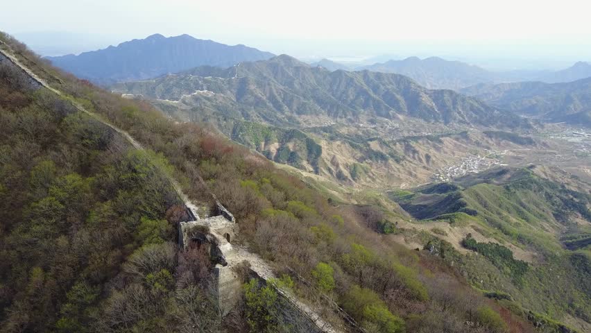 Adventure tourists hike remote wild section of Great Wall of China