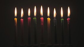 Time Lapse of colored Hanukkah Candles on black background  - Powered by Shutterstock - Get 15% off with code: PIKWIZARD15