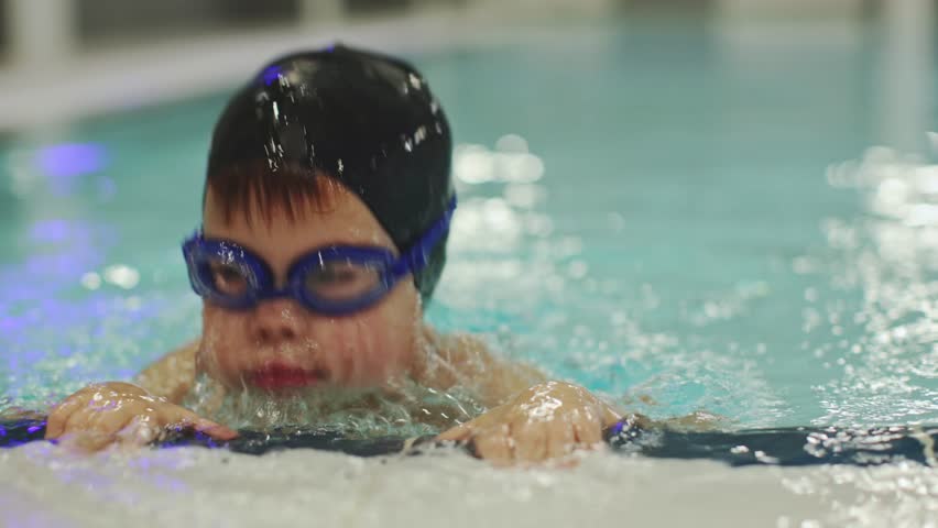 little preschooler boy in pool training child learning to breathe under water dive in swimming class. Male kid 4 years old in swimming cap goggles holding swimming pool side trains dive hold breath  Royalty-Free Stock Footage #1101379891