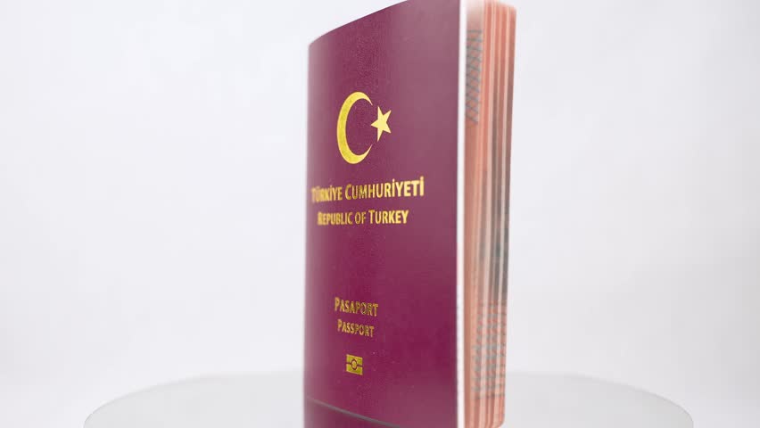 Isolated red coated turkish passport on a rotating platform with a white background Royalty-Free Stock Footage #1101379899