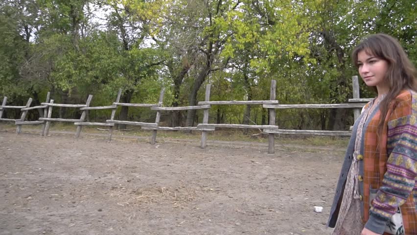 A beautiful country style girl in a horse corral