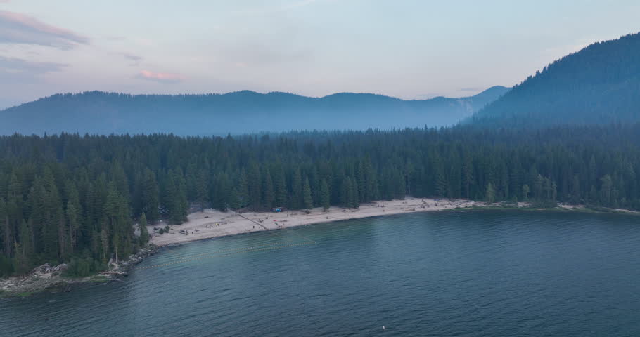 Lake Wenatchee State Park Washington USA Aerial Overview of Sandy Beach Shore and Mountainous Forests at Dusk on Summer Day