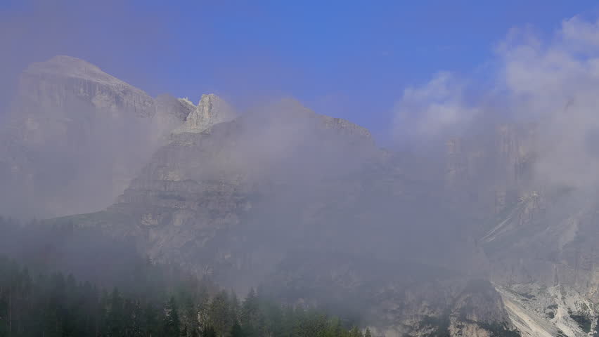 Timelapse of an amazing landscape at the Dolomites, Italy. View to the mountains, clouds and wood. Summer time