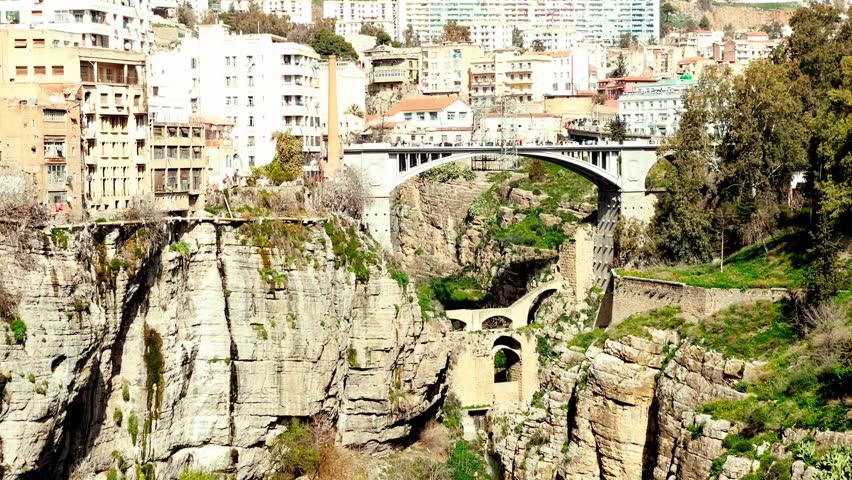 Wide view of a Constantine, Algeria Bridge: This footage captures the full scope of the iconic bridge, showcasing its unique design and its place in Constantine