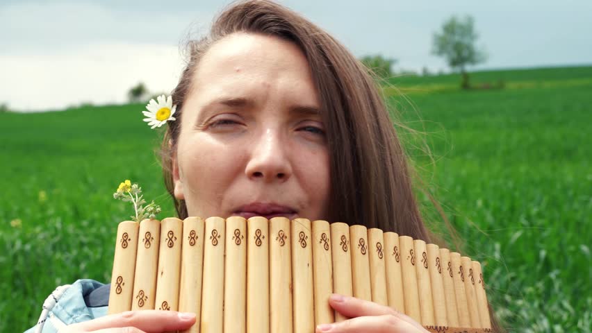 A young woman plays the panflute in nature Royalty-Free Stock Footage #1101384967