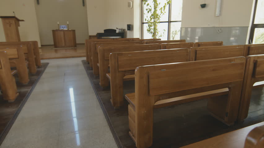 No people shot of wooden pews or bench seats in small Catholic church interior | Shutterstock HD Video #1101392609