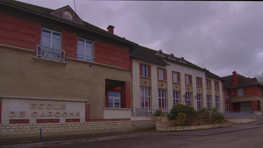 Shots of a school facade wide shots frame, movement of clouds over the roof of a modern building. Time lapse French schoolyard. Free European education in France