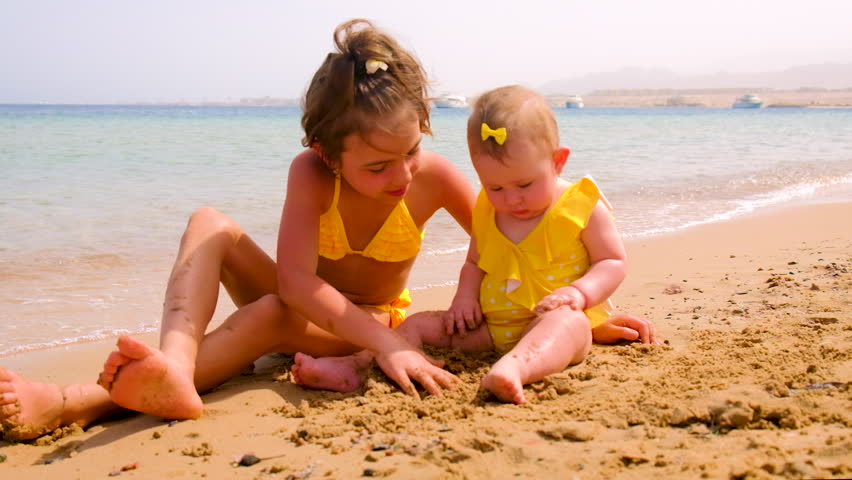 Children play with sand on the beach. Selective focus. Kid.
