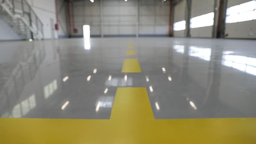 New hall with an epoxy floor would provide a durable and long-lasting surface that can withstand heavy foot traffic, abrasion, chemicals, and impact.  Royalty-Free Stock Footage #1101402217