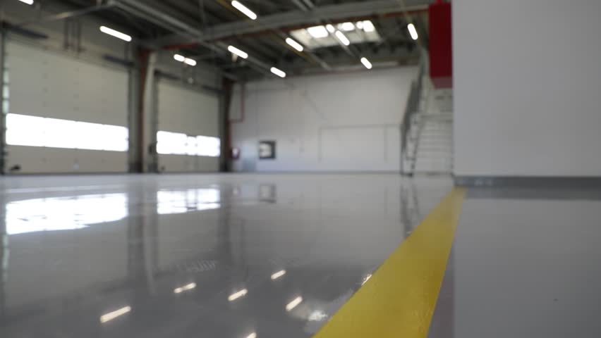 New hall with an epoxy floor would provide a durable and long-lasting surface that can withstand heavy foot traffic, abrasion, chemicals, and impact.  Royalty-Free Stock Footage #1101402221