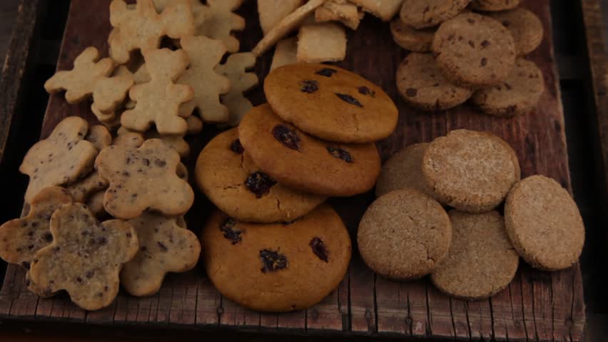 Set of different homemade cookies. Cookie close-up. Background from delicious pastries. Cookies with coconut, mishdal, chocolates, raisins, lingonberries. Round rhombuses, bears flowers shapes.