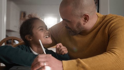 Multiracial father and son with Down syndrome using digital tablet Arkivvideo