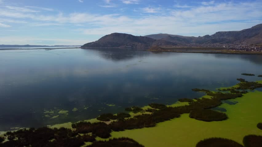 Aerial panorama of Puno with Lake Titicaca in Peru
