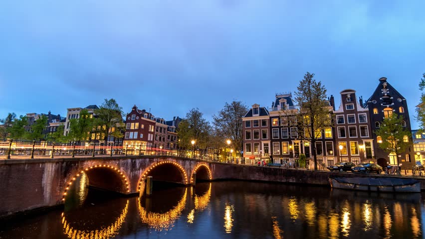Amsterdam Netherlands time lapse 4K, city skyline day to night timelapse at canal waterfront