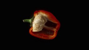 Red Bell pepper cut in half. Rotates on a black background. - Powered by Shutterstock - Get 15% off with code: PIKWIZARD15
