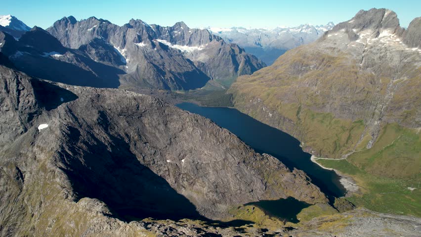 Impressive view oh high peaks scenery in Fiordland National Park, New Zealand. Aerial high rise panoramic.