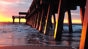 Waves crashing on the pier at Tybee Beach Tybee Island Georgia - Powered by Shutterstock - Get 15% off with code: PIKWIZARD15