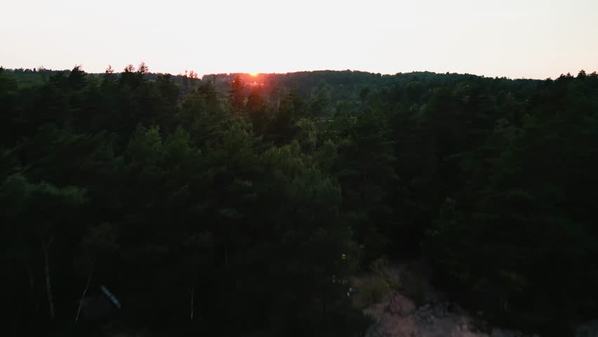 Aerial ascent of calm lake at sunset, Hällingsjö, Sweden