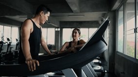 Fitness concept of 4k Resolution. Asian man and woman talking while exercising in the gym. - Powered by Shutterstock - Get 15% off with code: PIKWIZARD15
