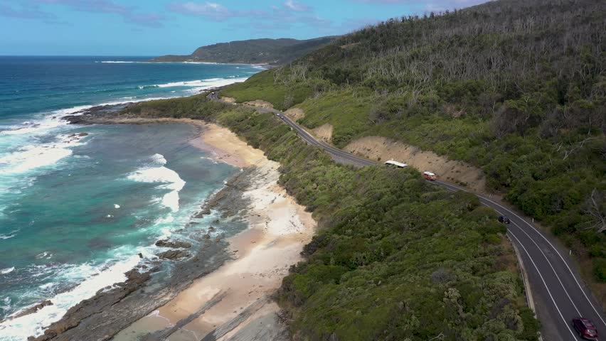 Great Ocean Road aerial view with bus, van, caravan and cars, Victoria, Australia