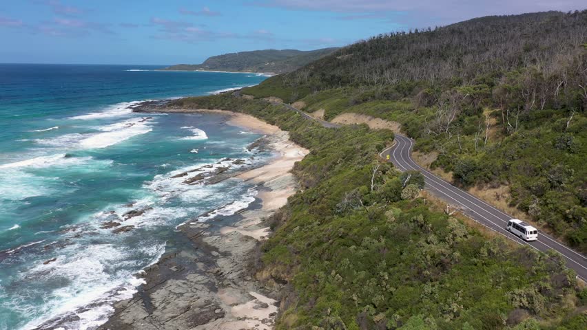 Bus and 4x4 car drive along Australia