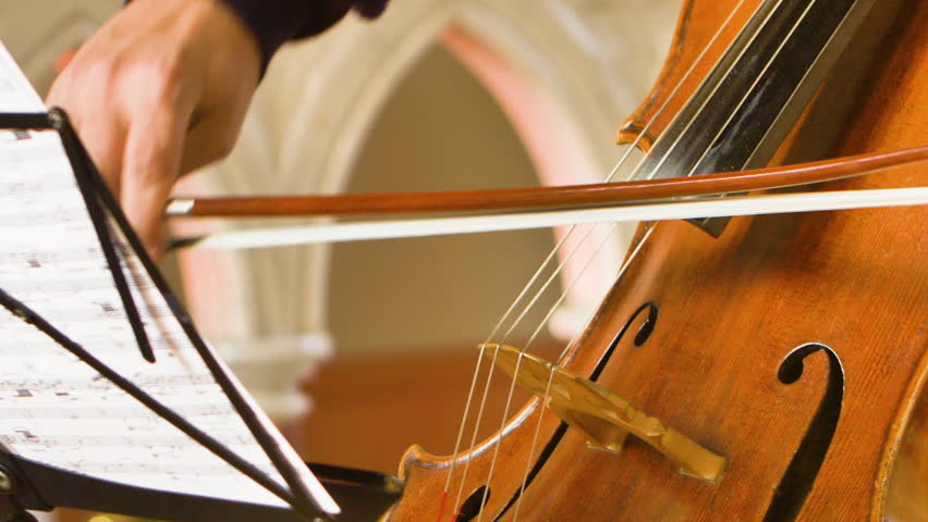Close up of male cellist playing in a string quartet in a small, bright church | Shutterstock HD Video #1101415397