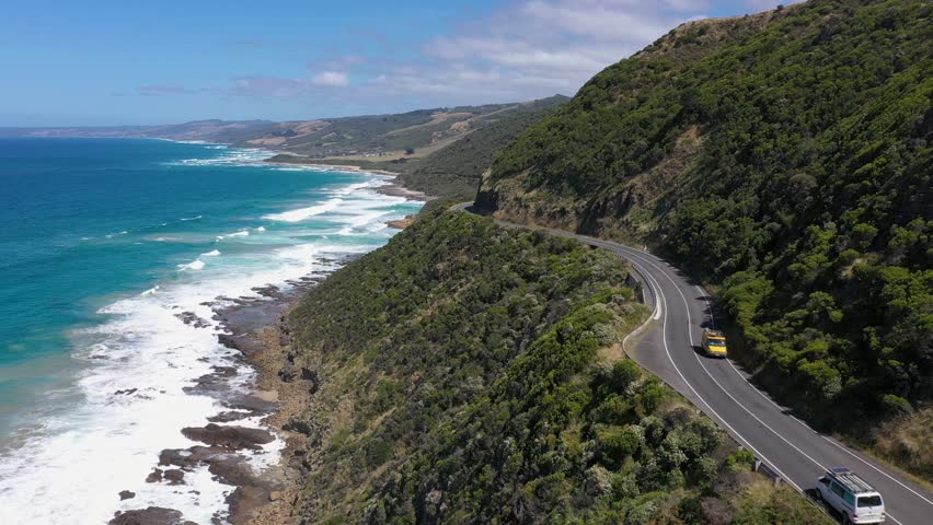 White van and red car drive along Australia