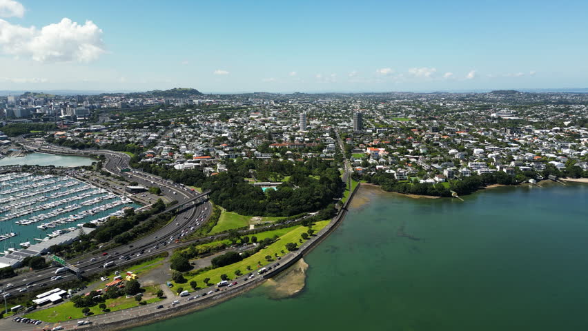 aerial footage of auckland city New Zealand NZ drone fly above stunning cityscape skyline during a sunny day of summer