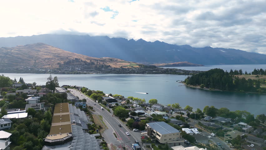 Aerial view over Central Queenstown, New Zealand with a beautiful lake and mountains in the background
